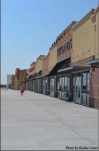 Shopping spree: A local shopper walks outside the local businesses on 82nd street. The grand opening of the Lawton Marketplace took place on July 28.