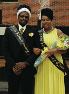 Lyndel Monrose and Karin Clashing-O’Reilly, both representing Students of the Carribean Alliance, pose for pictures after being crowned Homecoming King and Queen for 2014.